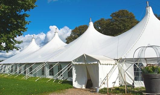 multiple portable restrooms in a row for added convenience at a concert venue in Dartmouth, MA